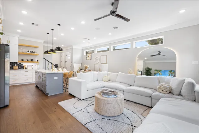 a living room with furniture and kitchen view