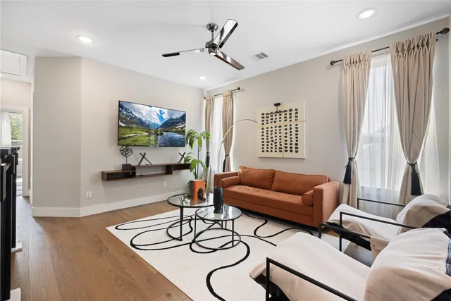 a spacious bathroom with a granite countertop sink a toilet a mirror and shower