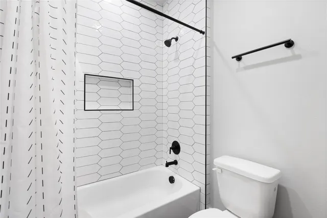 an aerial view of a house with garden space and street view