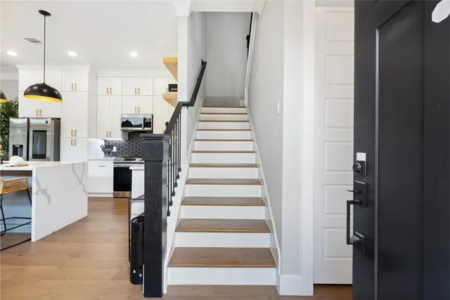 a view of entryway and hall with wooden floor