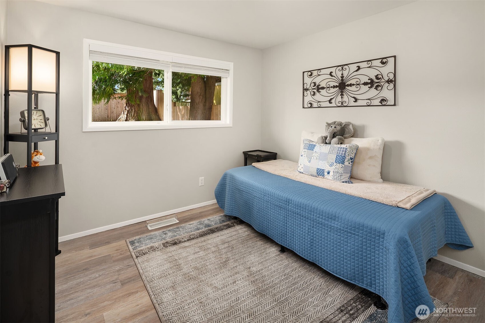 1067 Anacortes Avenue Northeast Renton, WA 98059 - Photo 17 of 34 a room with a bed and a painting on the wall