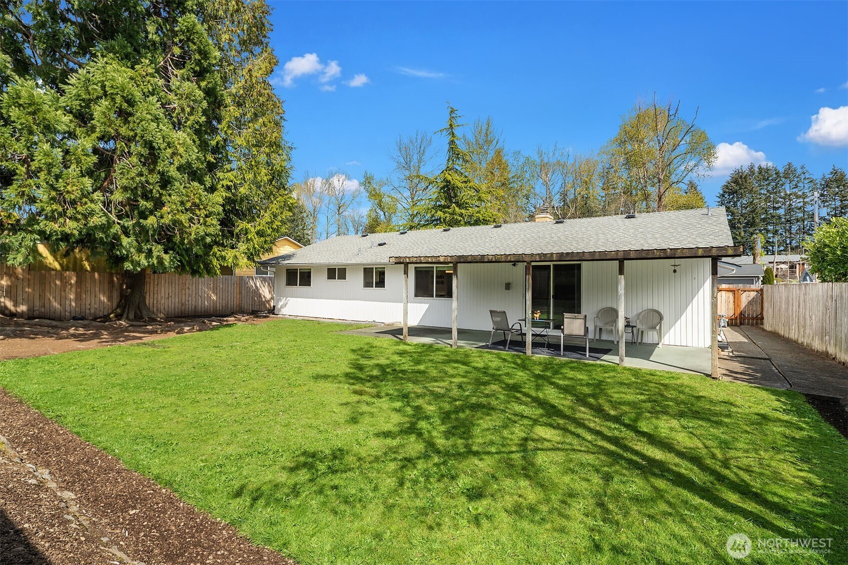 1067 Anacortes Avenue Northeast Renton, WA 98059 - Photo 21 of 34 a front view of a house with garden and trees