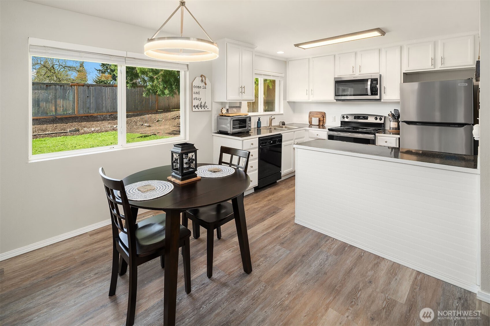 1067 Anacortes Avenue Northeast Renton, WA 98059 - Photo 6 of 34 a kitchen with a stove a refrigerator and a dining table