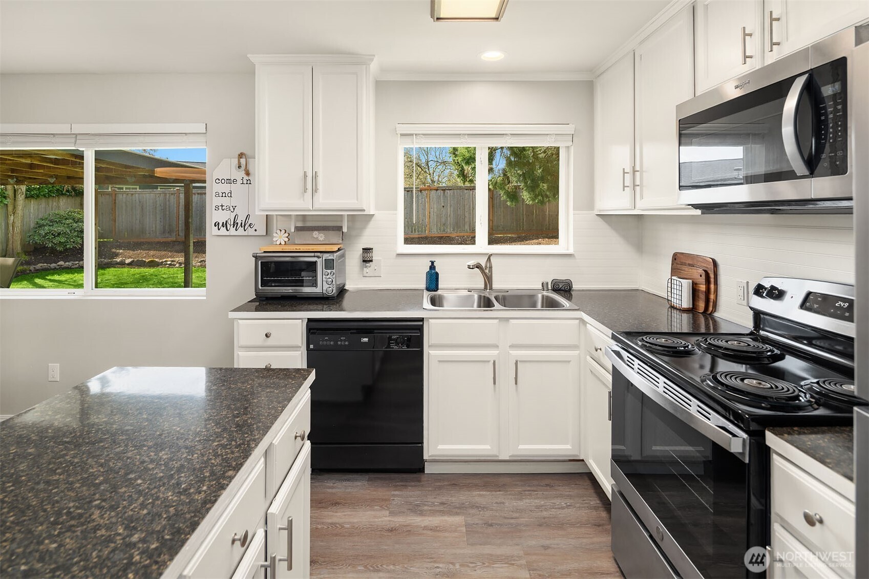1067 Anacortes Avenue Northeast Renton, WA 98059 - Photo 9 of 34 a kitchen with stainless steel appliances granite countertop a stove a sink and a microwave