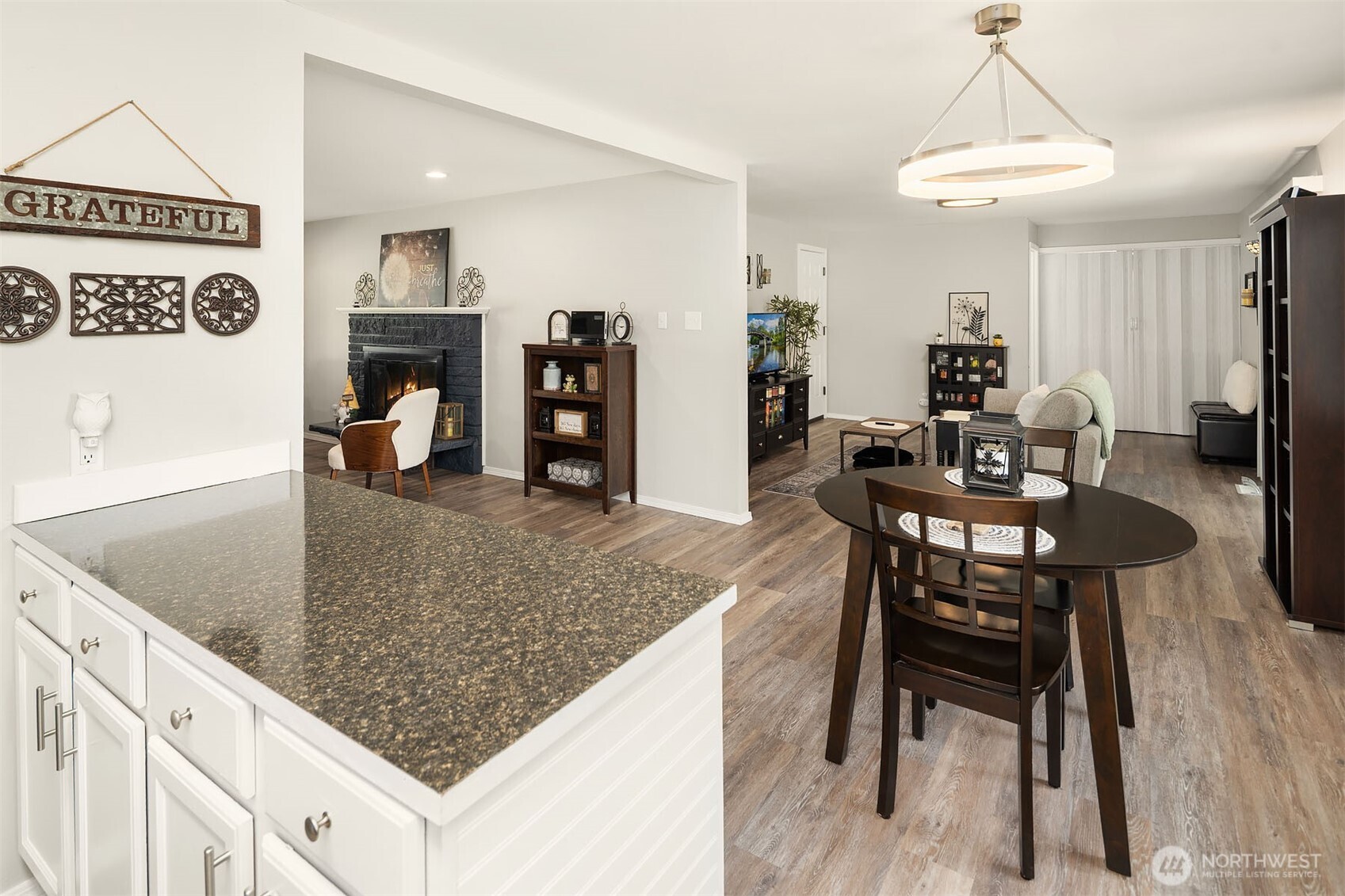 1067 Anacortes Avenue Northeast Renton, WA 98059 - Photo 10 of 34 a kitchen with stainless steel appliances granite countertop a table chairs and a refrigerator