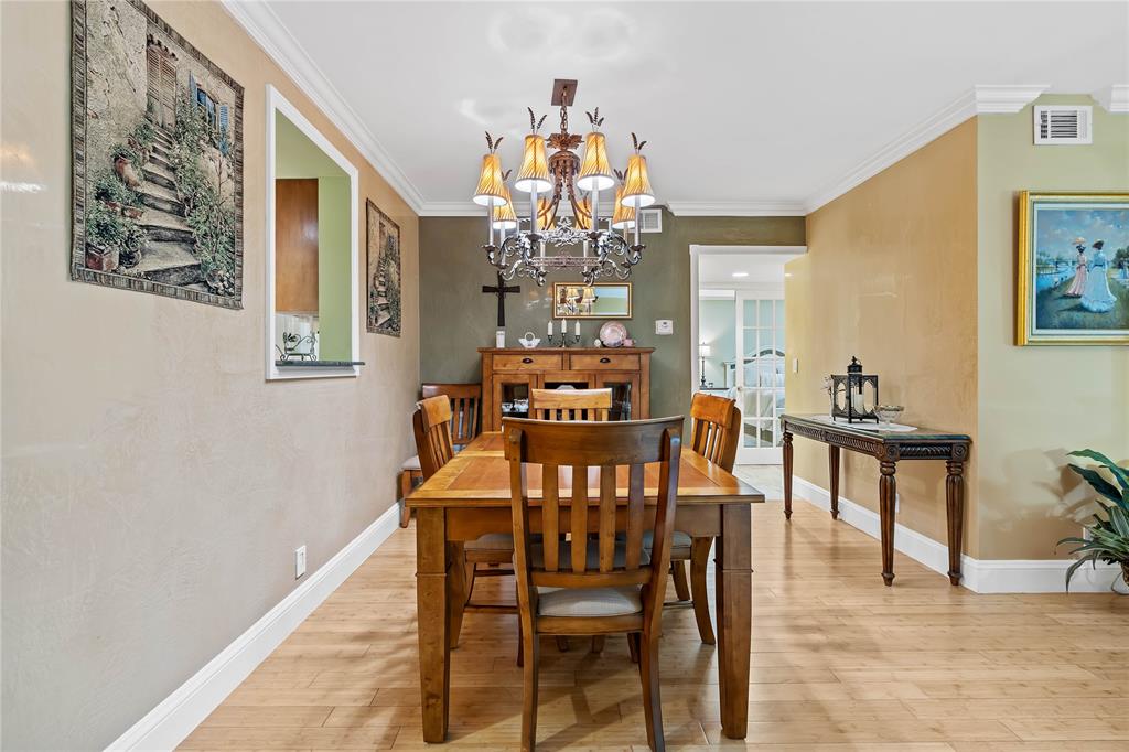 7970 La Mirada Drive, Unit 20 Boca Raton, FL 33433 - Photo 11 of 38 a view of a dining room with furniture and chandelier