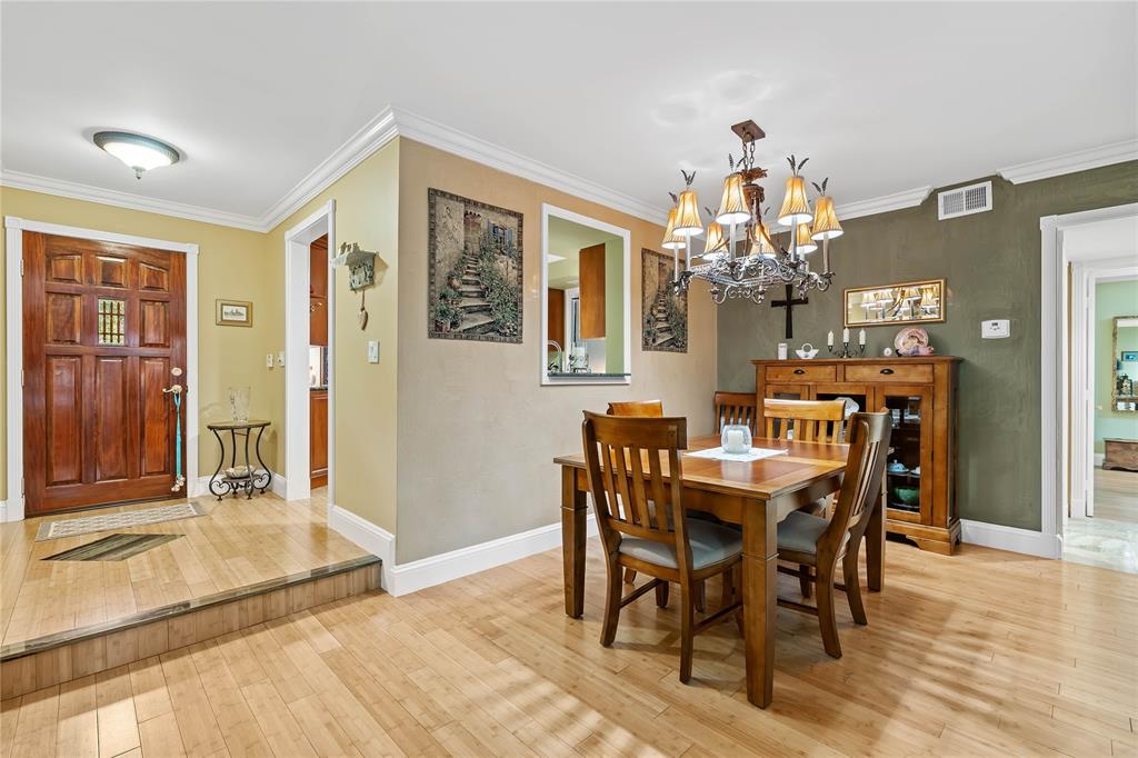 7970 La Mirada Drive, Unit 20 Boca Raton, FL 33433 - Photo 12 of 38 a view of a dining room with furniture and chandelier