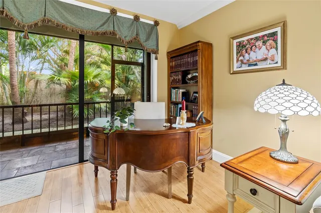 a view of a workspace with furniture and a window