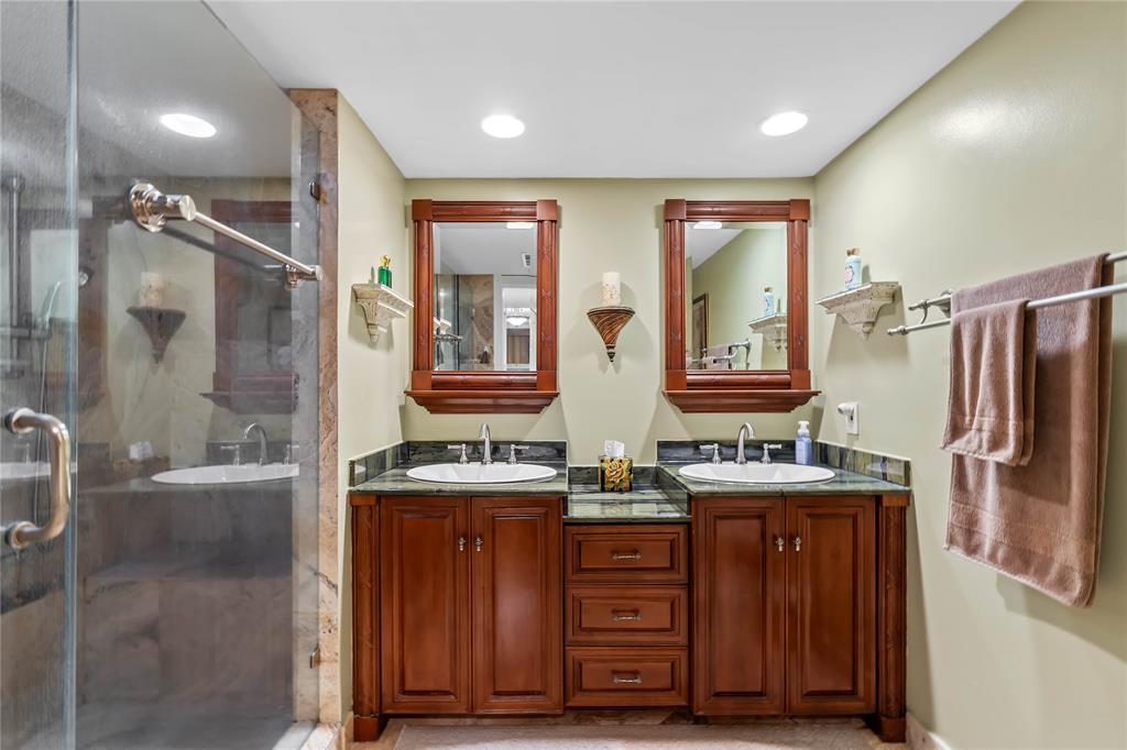 7970 La Mirada Drive, Unit 20 Boca Raton, FL 33433 - Photo 23 of 38 a bathroom with a sink a mirror and a shower