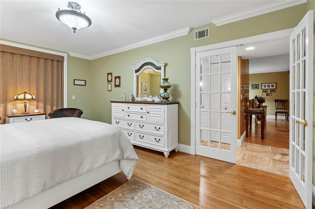 7970 La Mirada Drive, Unit 20 Boca Raton, FL 33433 - Photo 27 of 38 a bedroom with a bed and wooden floor