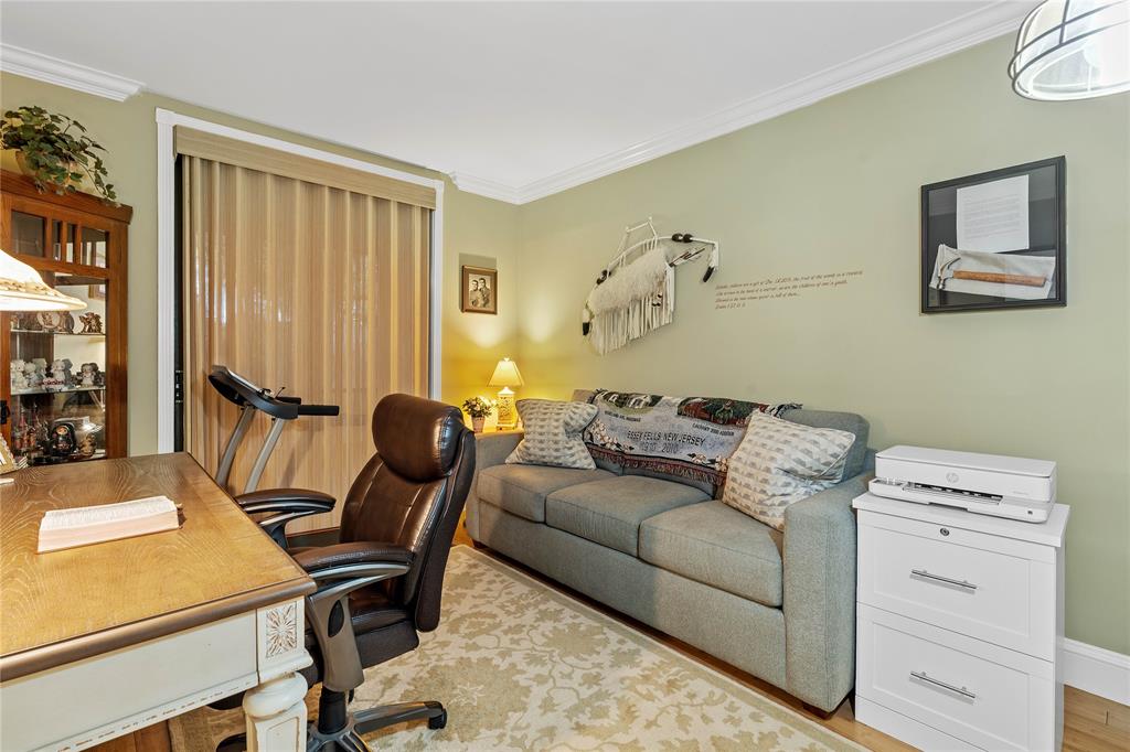 7970 La Mirada Drive, Unit 20 Boca Raton, FL 33433 - Photo 28 of 38 a living room with furniture a flat screen tv and a window