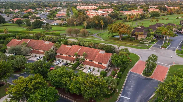 an aerial view of a house with a garden and lake view