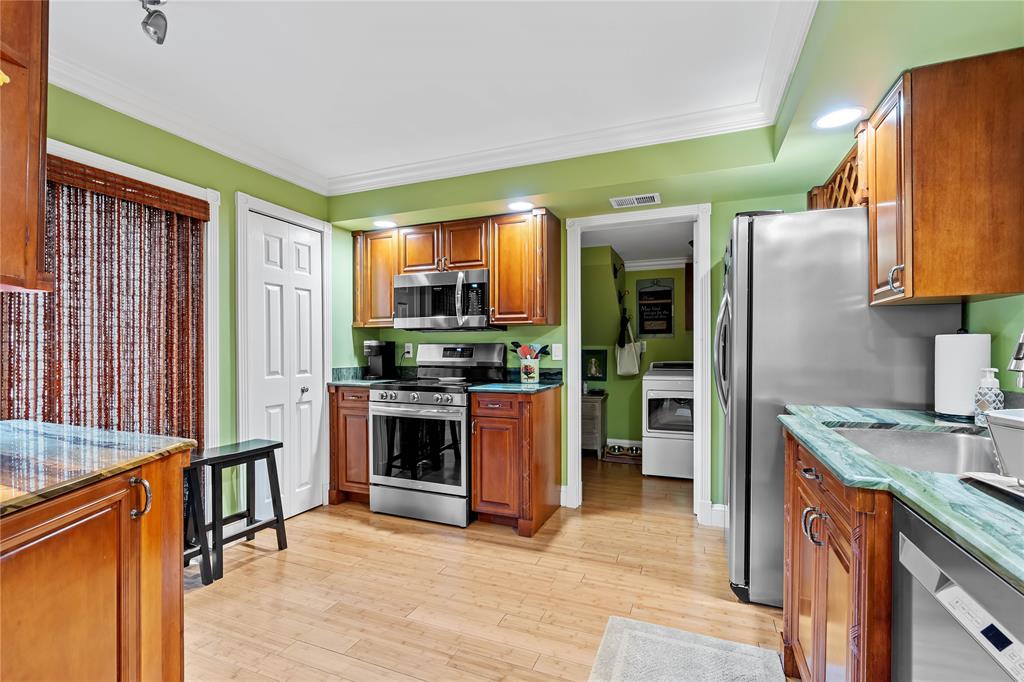 7970 La Mirada Drive, Unit 20 Boca Raton, FL 33433 - Photo 7 of 38 a kitchen with stainless steel appliances granite countertop a refrigerator a stove and a sink with cabinets
