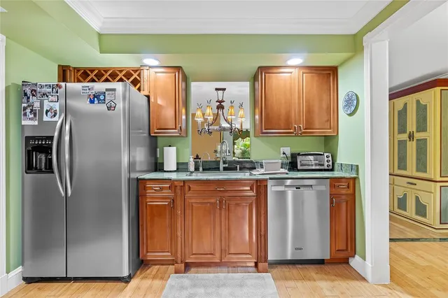 a kitchen with stainless steel appliances granite countertop a refrigerator and a stove
