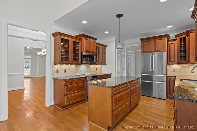 a kitchen with stainless steel appliances granite countertop a stove and a microwave