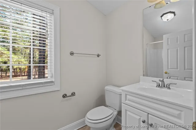 en empty room with windows and fan