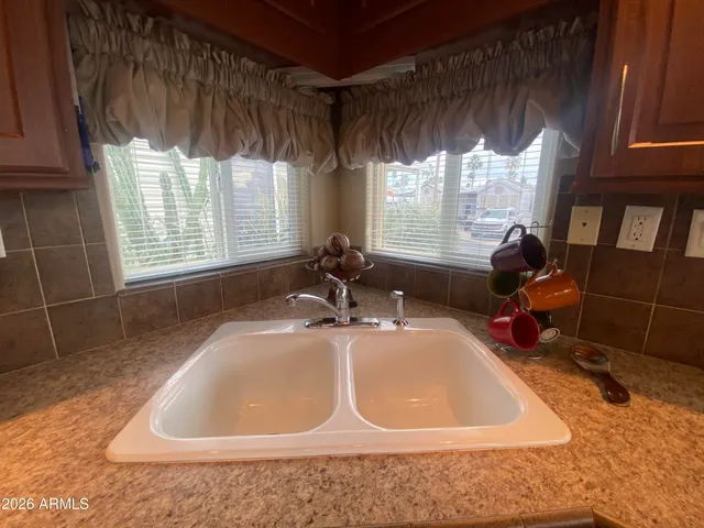 a bathroom with a tub a sink and window
