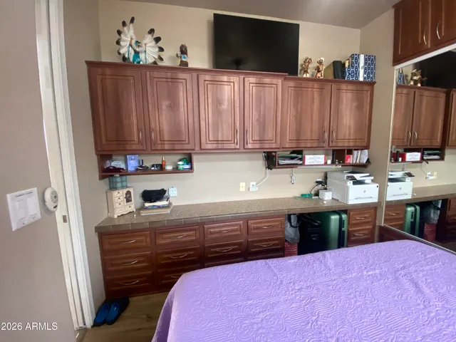 a bathroom with a granite countertop sink a mirror and a vanity