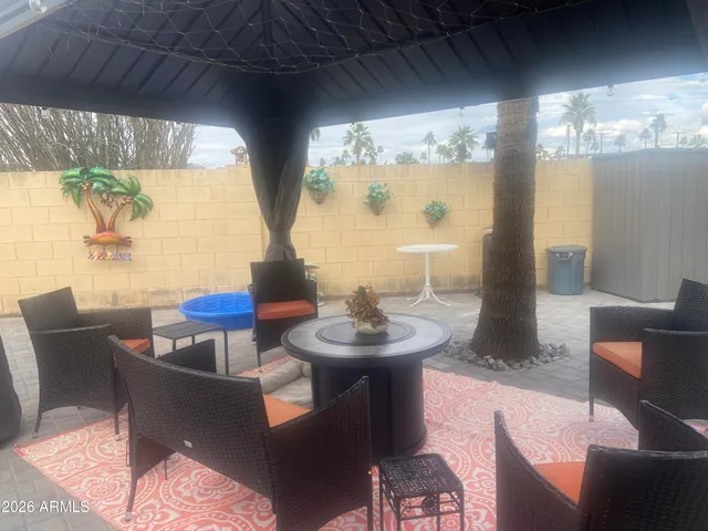 a living room with fireplace furniture and a large window