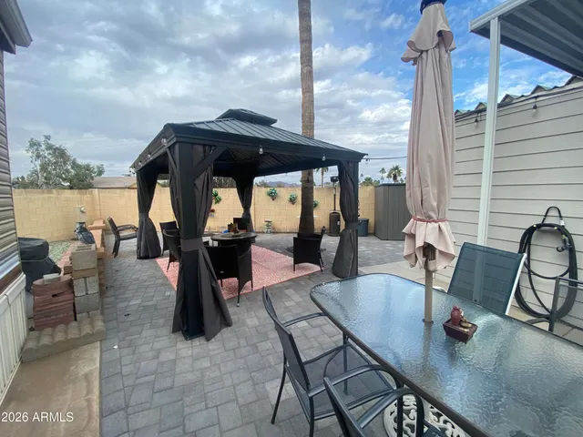 a dining room with furniture a rug and a floor to ceiling window