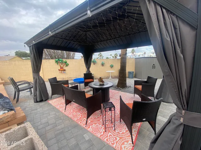 a view of dinning table and chairs in patio