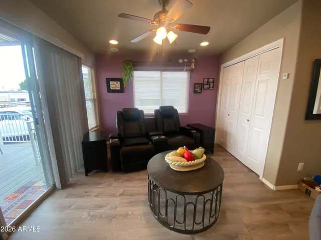a living room with furniture and a floor to ceiling window