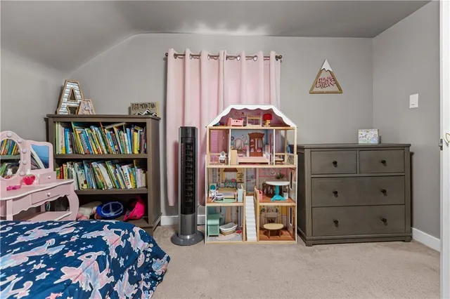 a living room with furniture and a book shelf