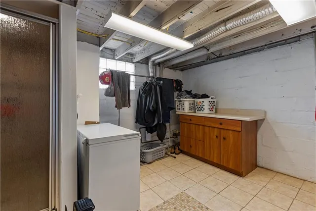 a view of storage and utility room with refrigerator