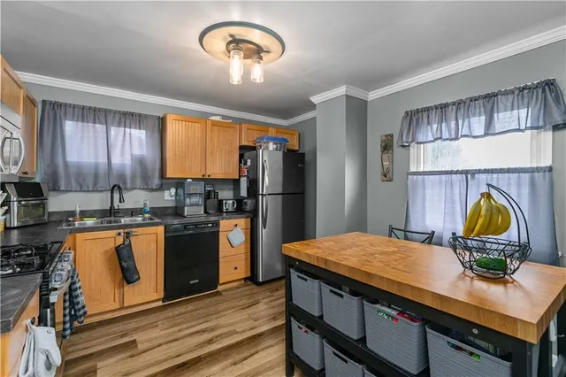 a kitchen with a refrigerator and a stove top oven