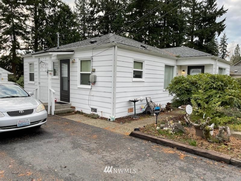 504 Morgan Road Everett, WA 98203 - Photo 2 of 2 a view of a white house with a large space and large trees