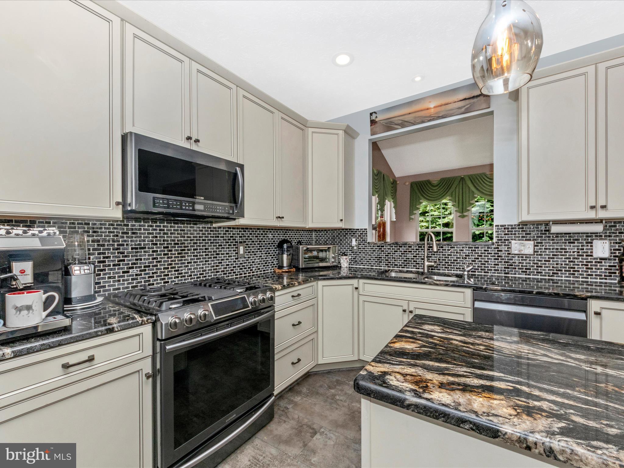 7732 Rotherham Drive Hanover, MD 21076 - Photo 3 of 55 a kitchen with granite countertop a stove and a microwave
