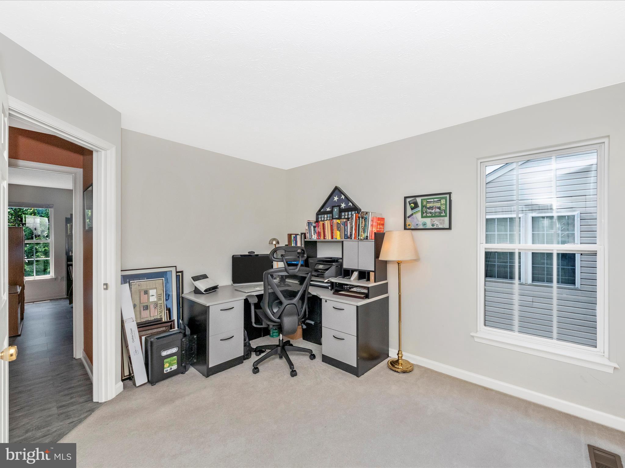 7732 Rotherham Drive Hanover, MD 21076 - Photo 31 of 55 a view of a workspace with furniture and a window