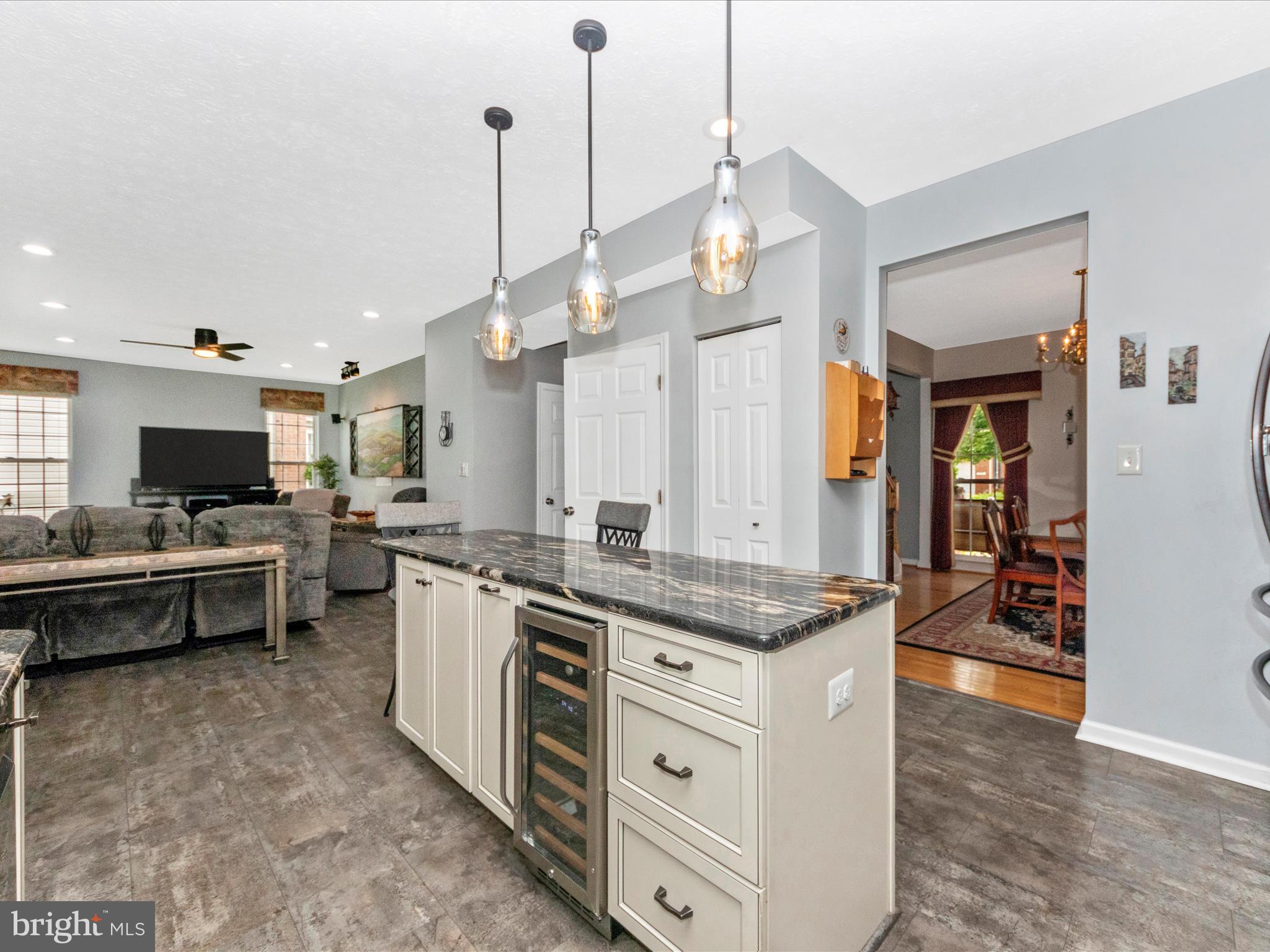 7732 Rotherham Drive Hanover, MD 21076 - Photo 5 of 55 a large kitchen with kitchen island a stove a sink a dining table and chairs
