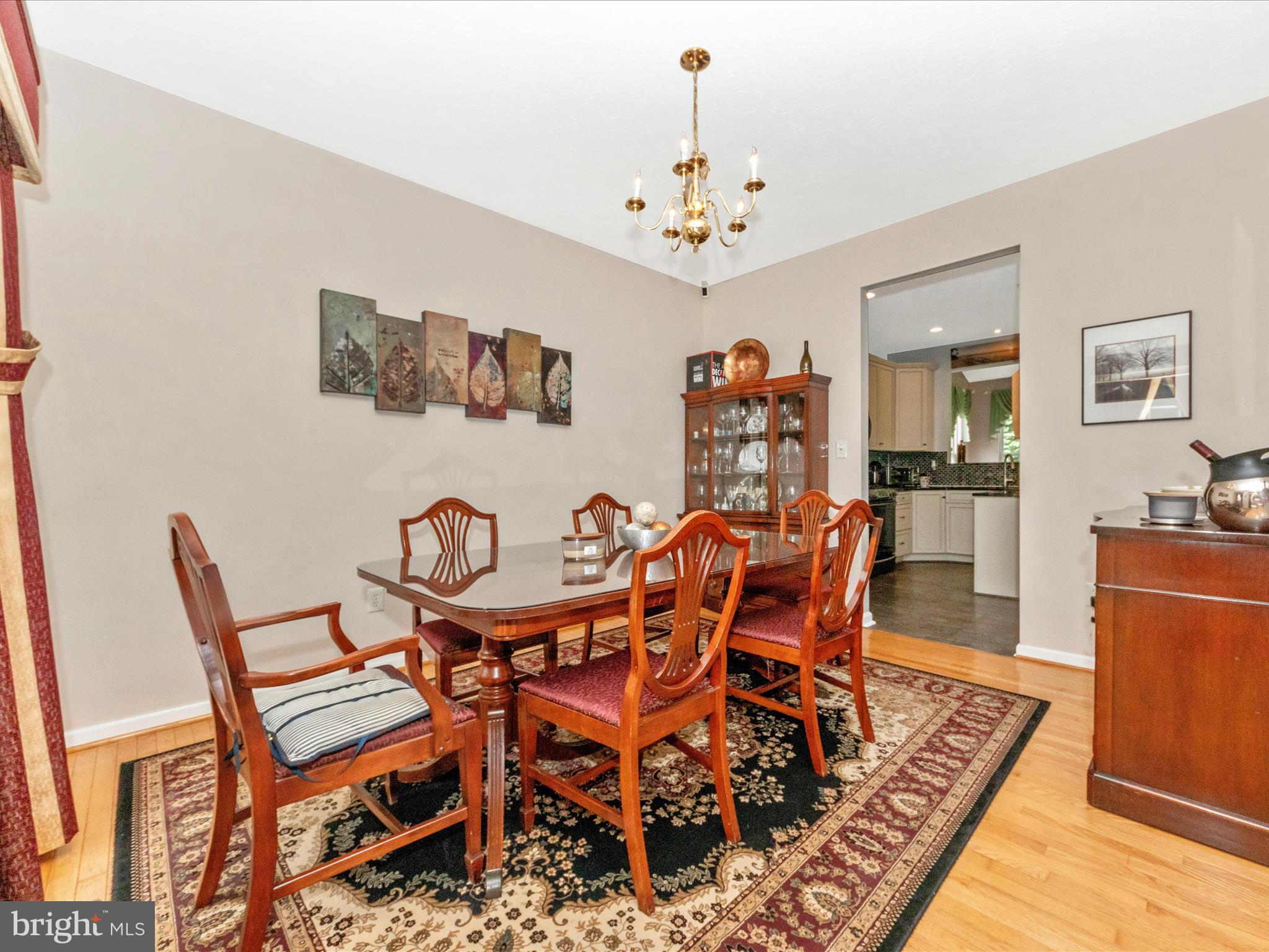 7732 Rotherham Drive Hanover, MD 21076 - Photo 8 of 55 a dining room with furniture a rug and wooden floor