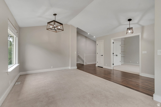 2154 Wasatch Boulevard Sandy, UT 84092 - Photo 4 of 55 Unfurnished dining area with dark carpet, vaulted ceiling, a chandelier, and dark wood-style flooring