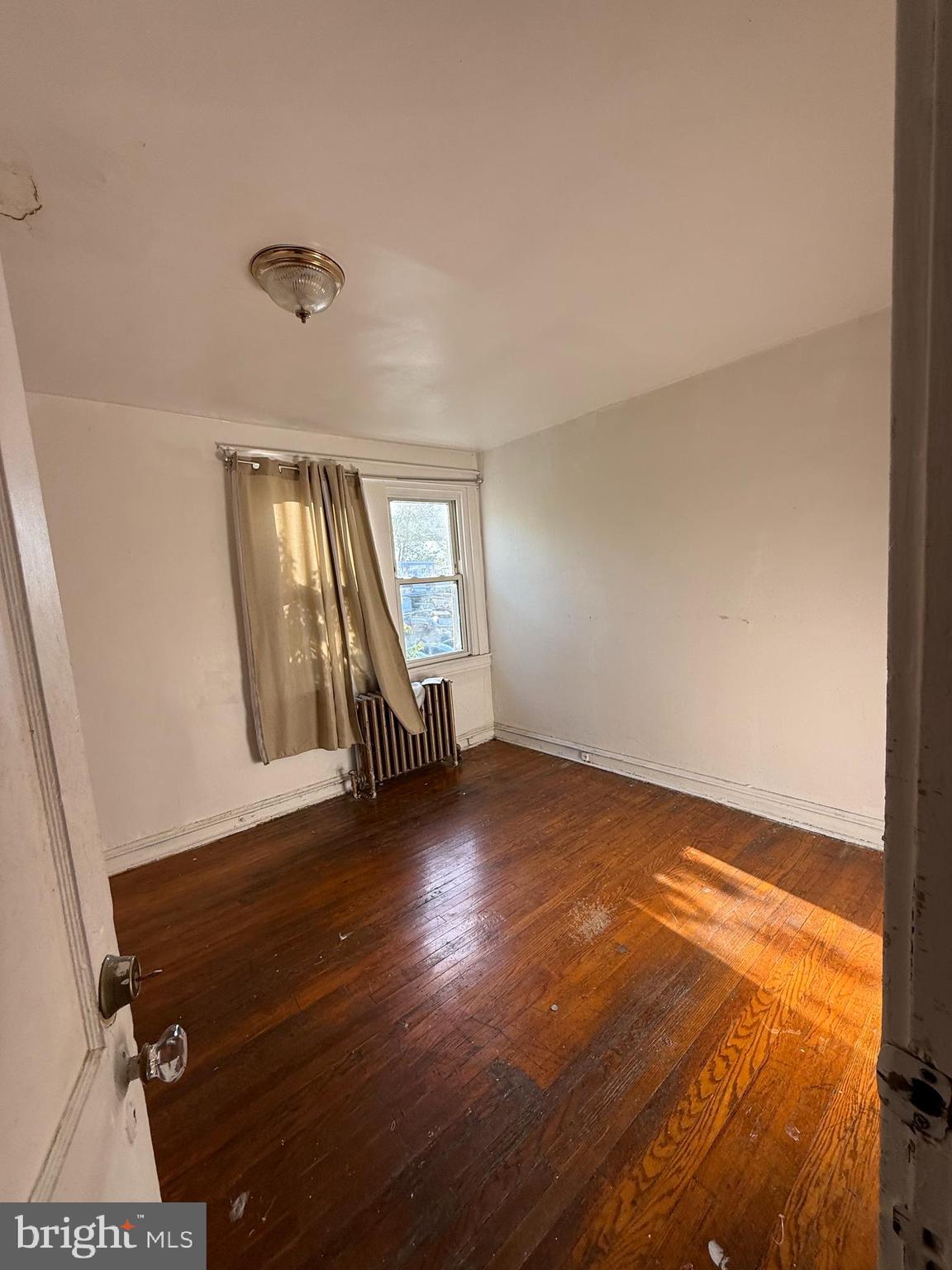 411 Timberlake Road Upper Darby, PA 19082 - Photo 12 of 15 an empty room with wooden floor and windows