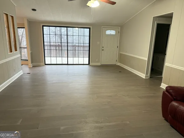 wooden floor in an empty room with a window