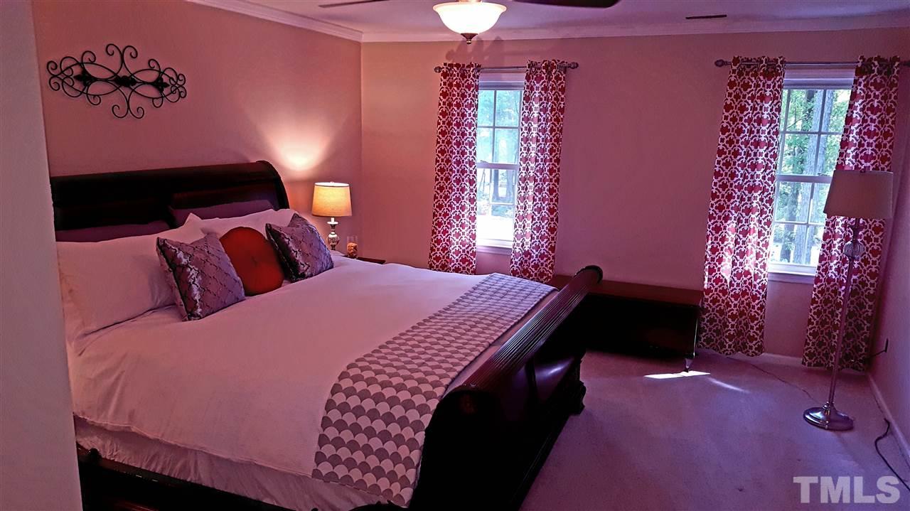 1113 Hamilton Way Durham, NC 27713 - Photo 14 of 25 a bedroom with a bed and a lamp