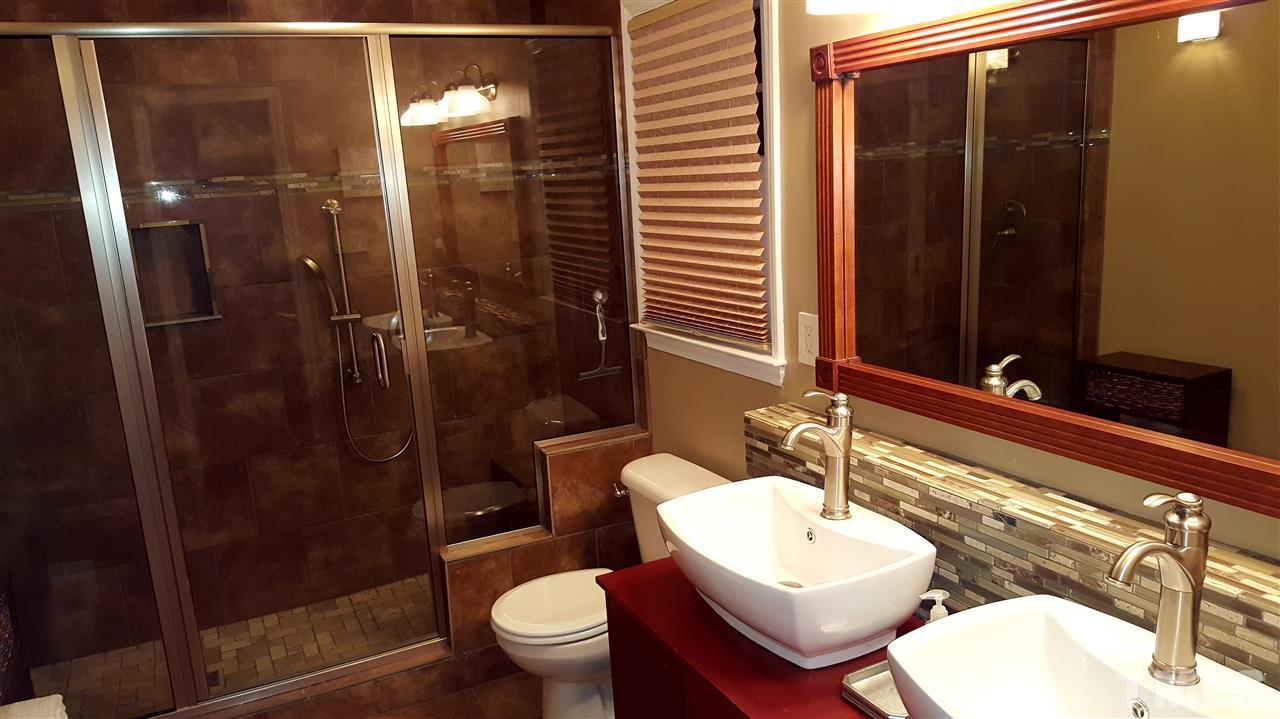 1113 Hamilton Way Durham, NC 27713 - Photo 16 of 25 a bathroom with a toilet sink shower and mirror