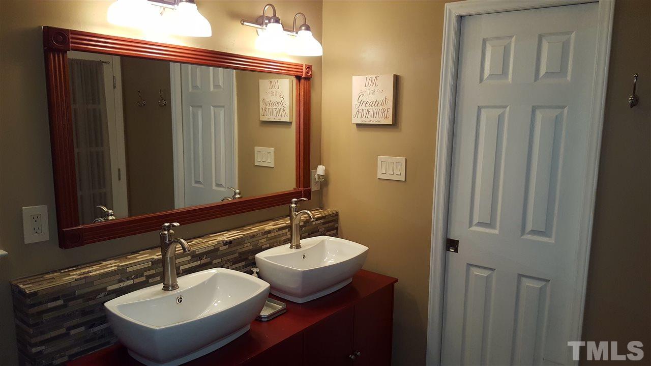 1113 Hamilton Way Durham, NC 27713 - Photo 17 of 25 a bathroom with a sink and a mirror