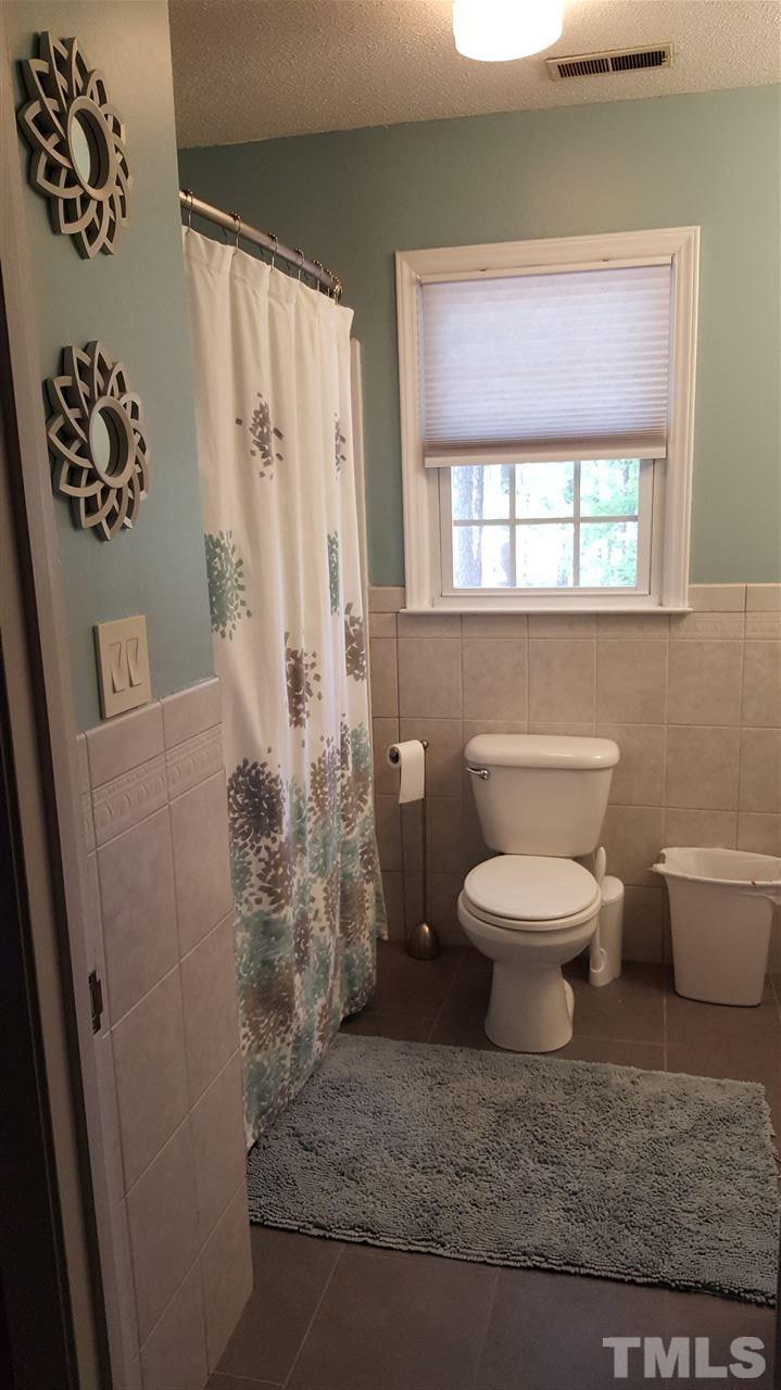 1113 Hamilton Way Durham, NC 27713 - Photo 21 of 25 a white toilet sitting next to a bathroom sink