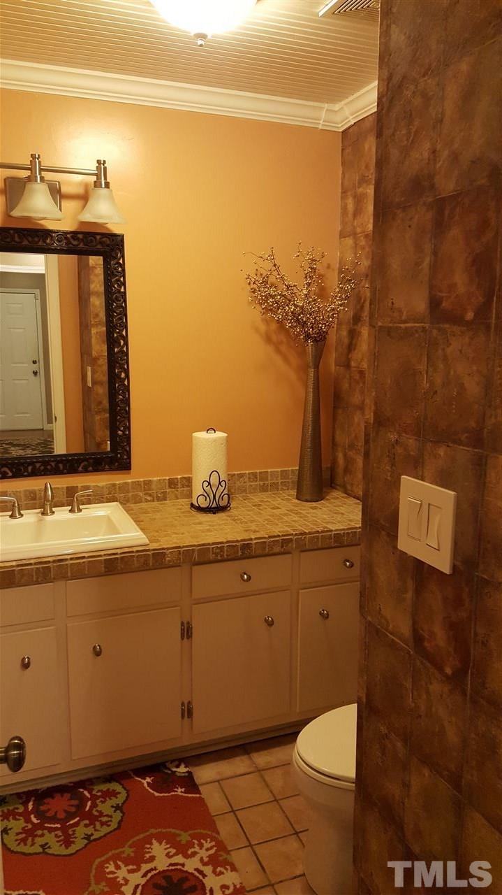 1113 Hamilton Way Durham, NC 27713 - Photo 8 of 25 a bathroom with a granite countertop sink and a mirror