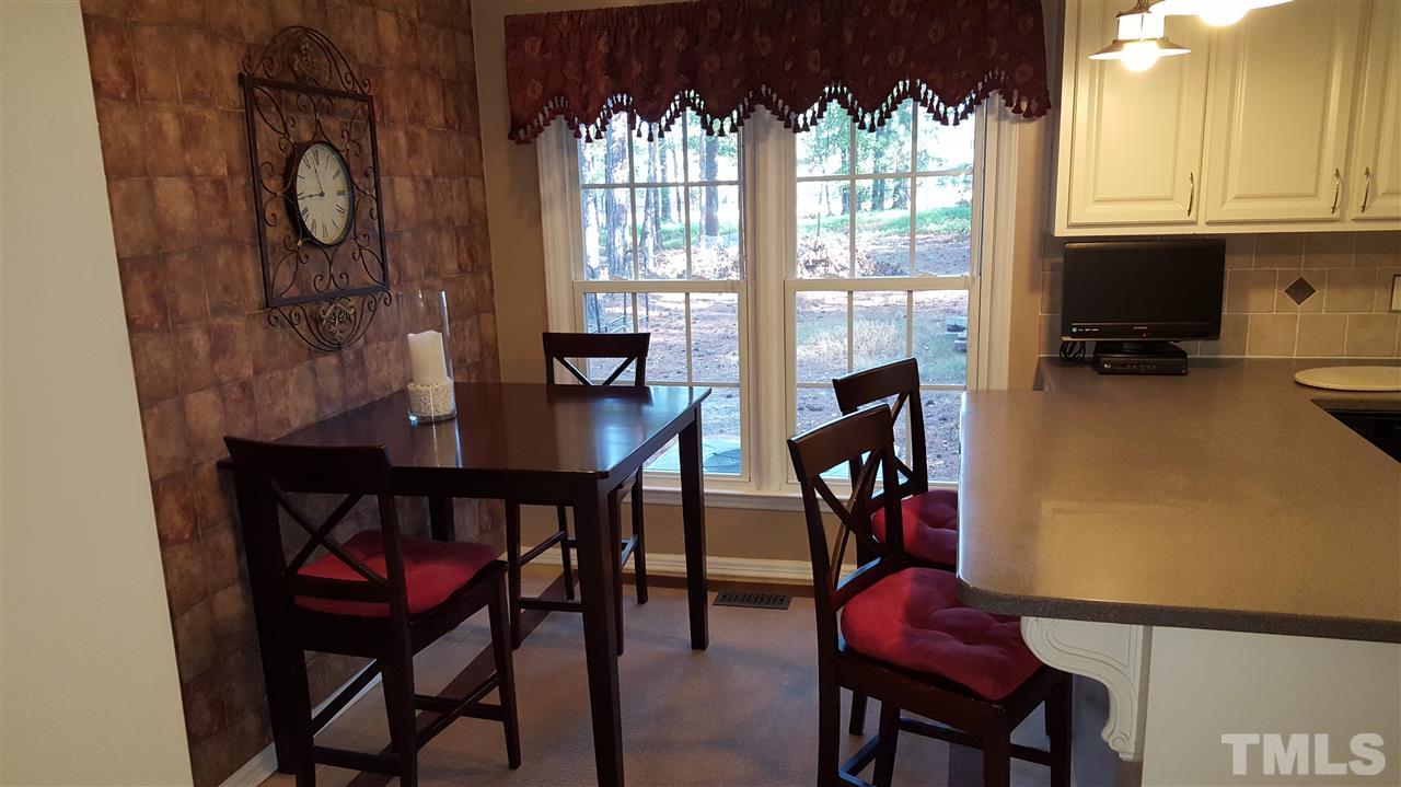 1113 Hamilton Way Durham, NC 27713 - Photo 9 of 25 a view of a dining room with furniture window and outside view