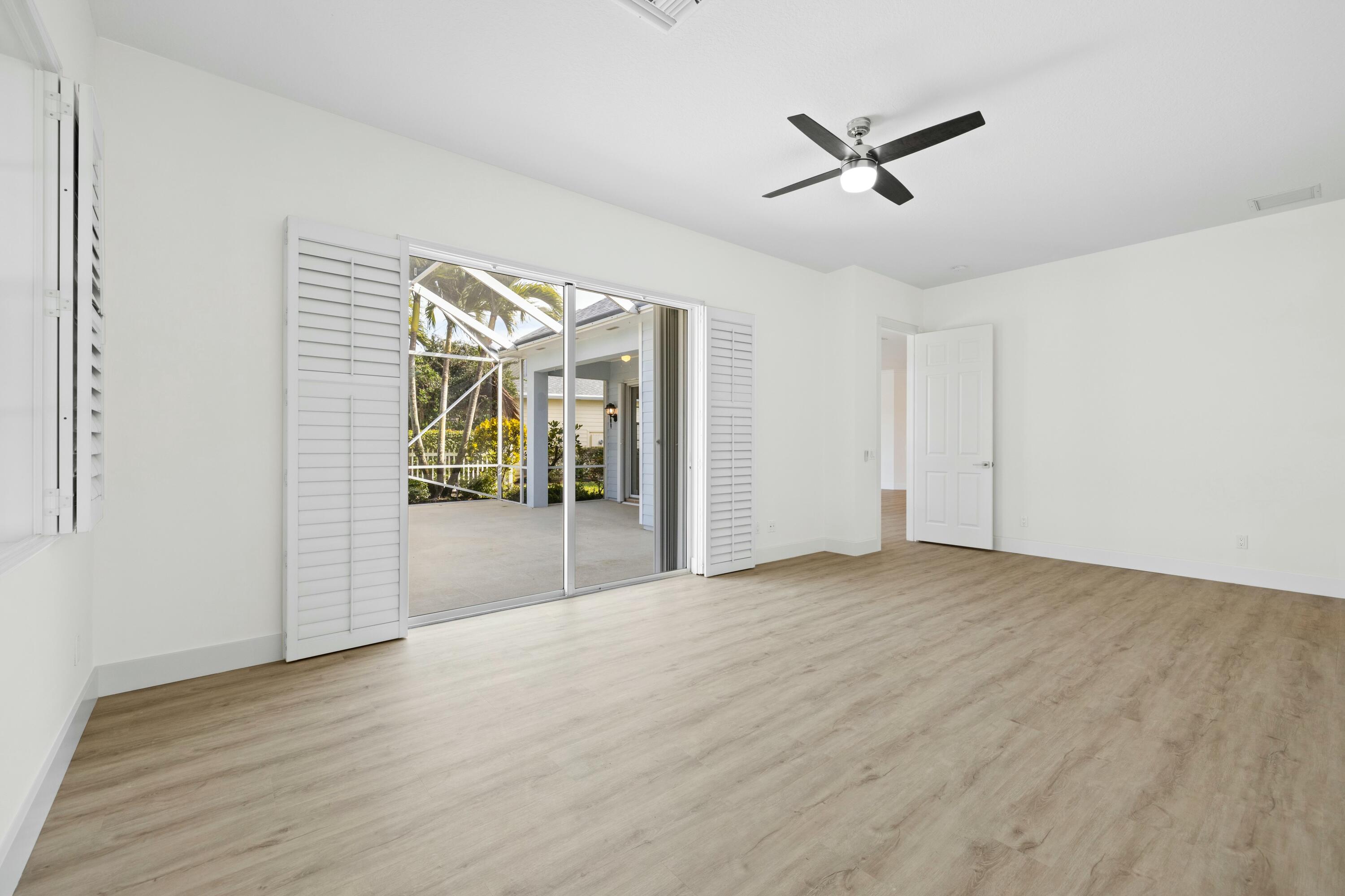 140 Barbados Drive Jupiter, FL 33458 - Photo 16 of 42 a view of a livingroom with a ceiling fan and wooden floor
