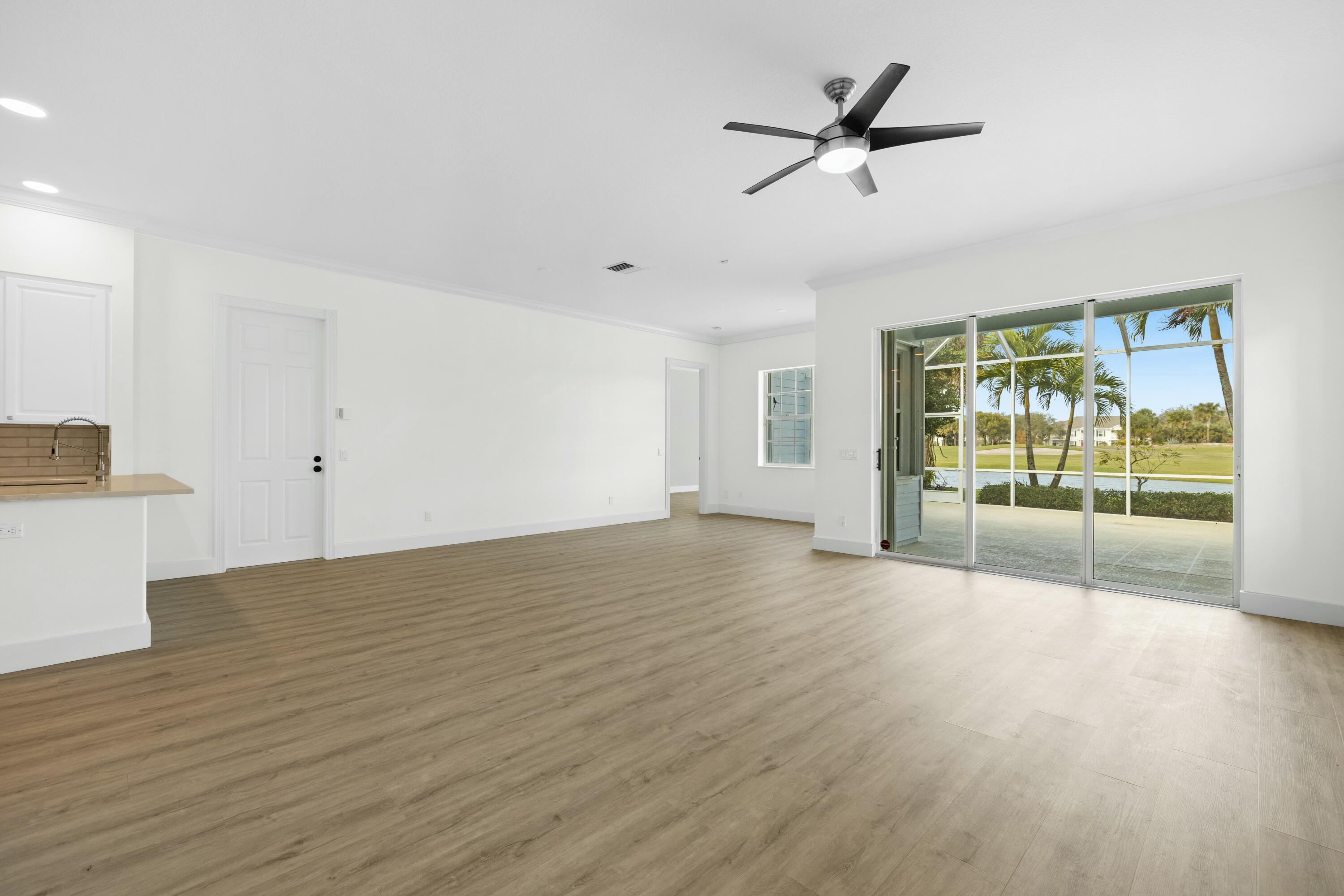 140 Barbados Drive Jupiter, FL 33458 - Photo 18 of 42 a view of an empty room with a window and wooden floor