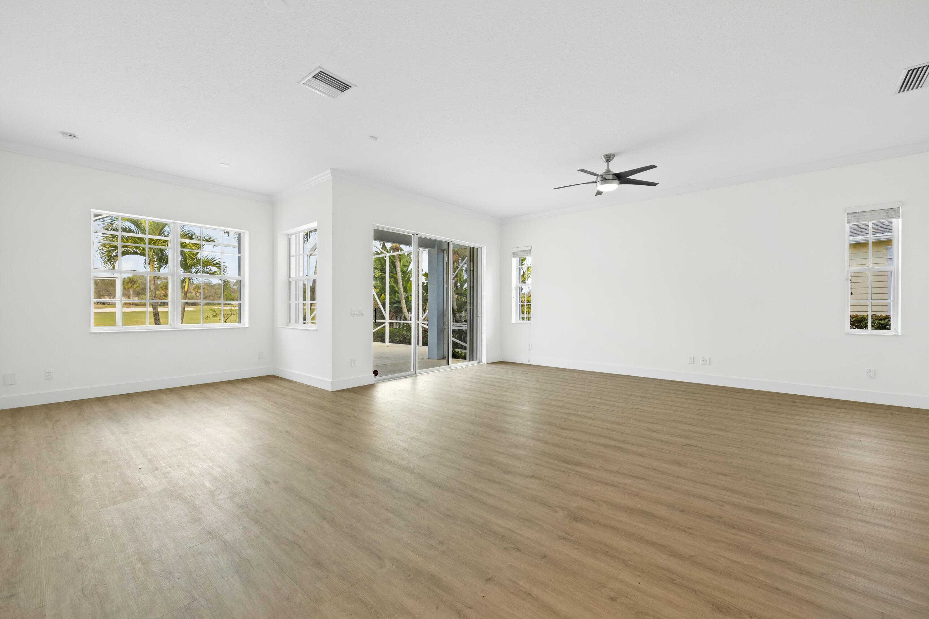 140 Barbados Drive Jupiter, FL 33458 - Photo 19 of 42 a view of an empty room with a window and wooden floor