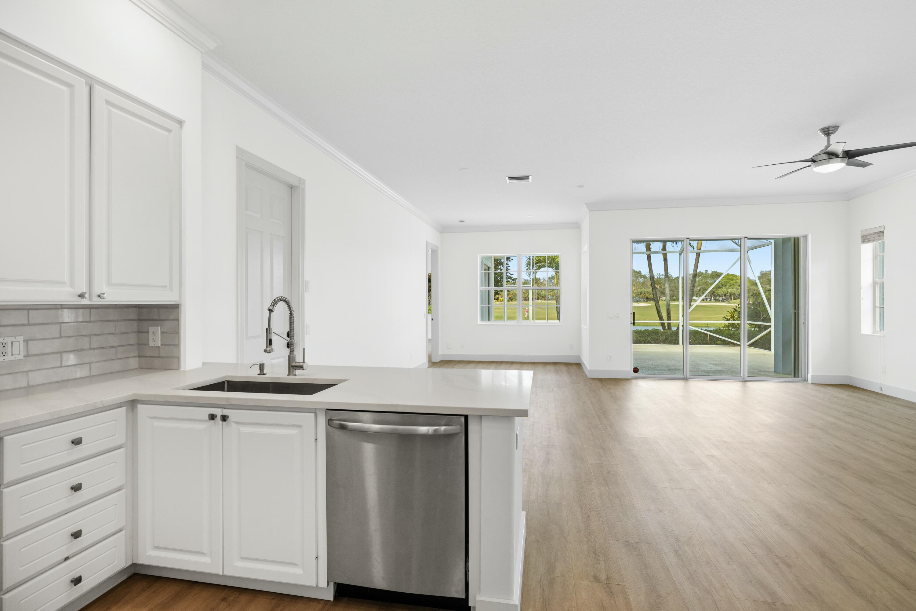 140 Barbados Drive Jupiter, FL 33458 - Photo 20 of 42 a kitchen with granite countertop a sink and a window
