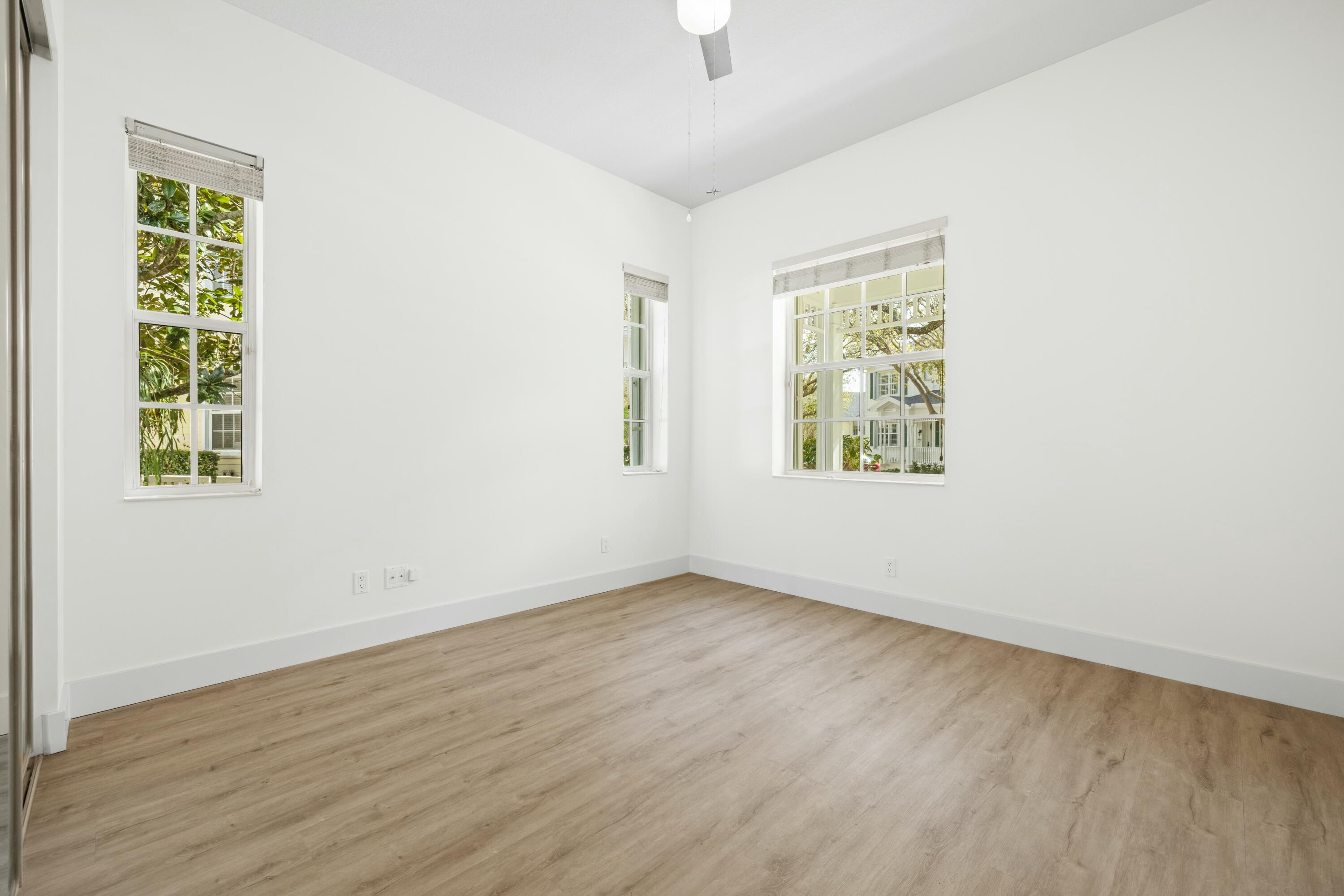 140 Barbados Drive Jupiter, FL 33458 - Photo 25 of 42 an empty room with wooden floor and windows