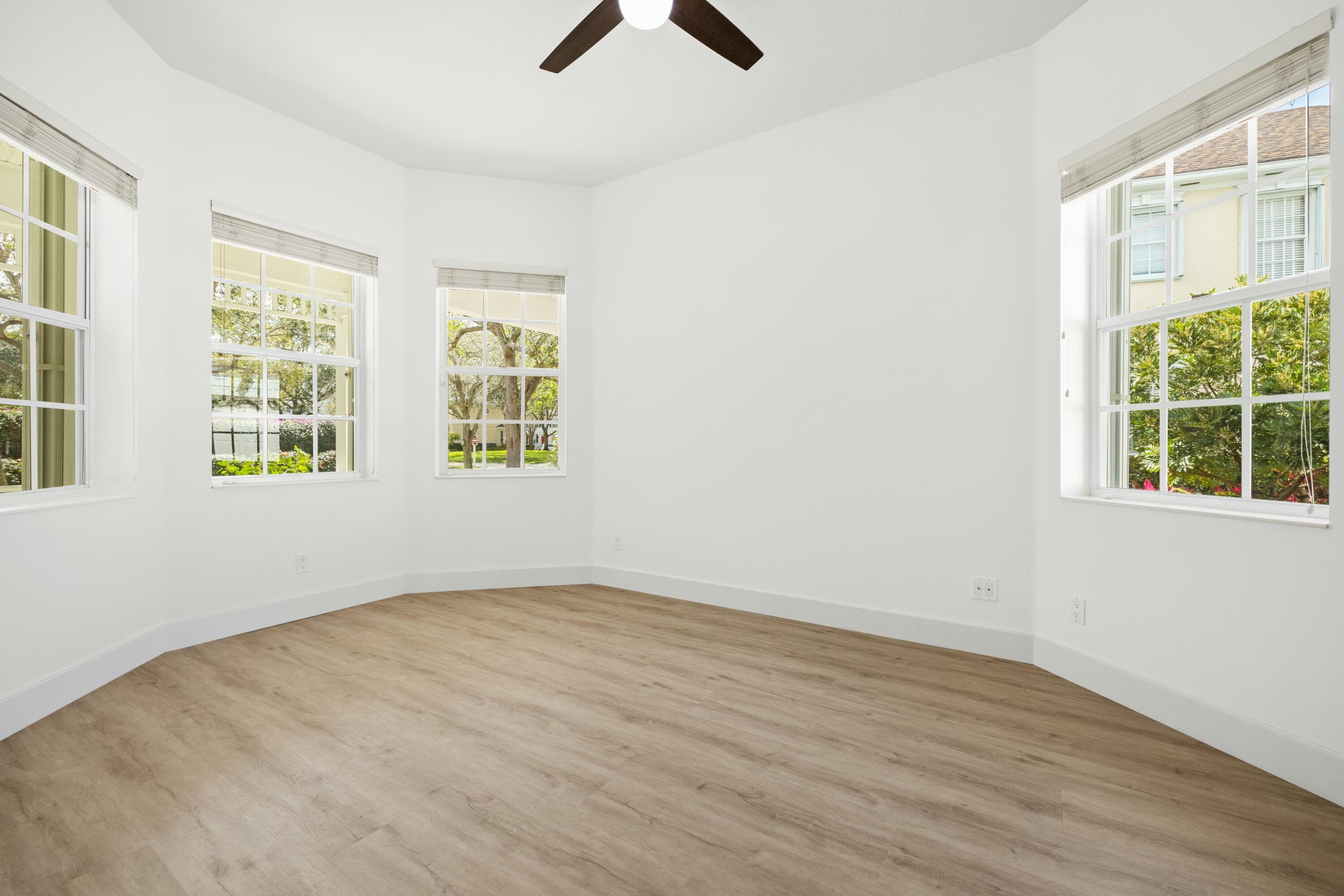 140 Barbados Drive Jupiter, FL 33458 - Photo 26 of 42 wooden floor in an empty room with a window