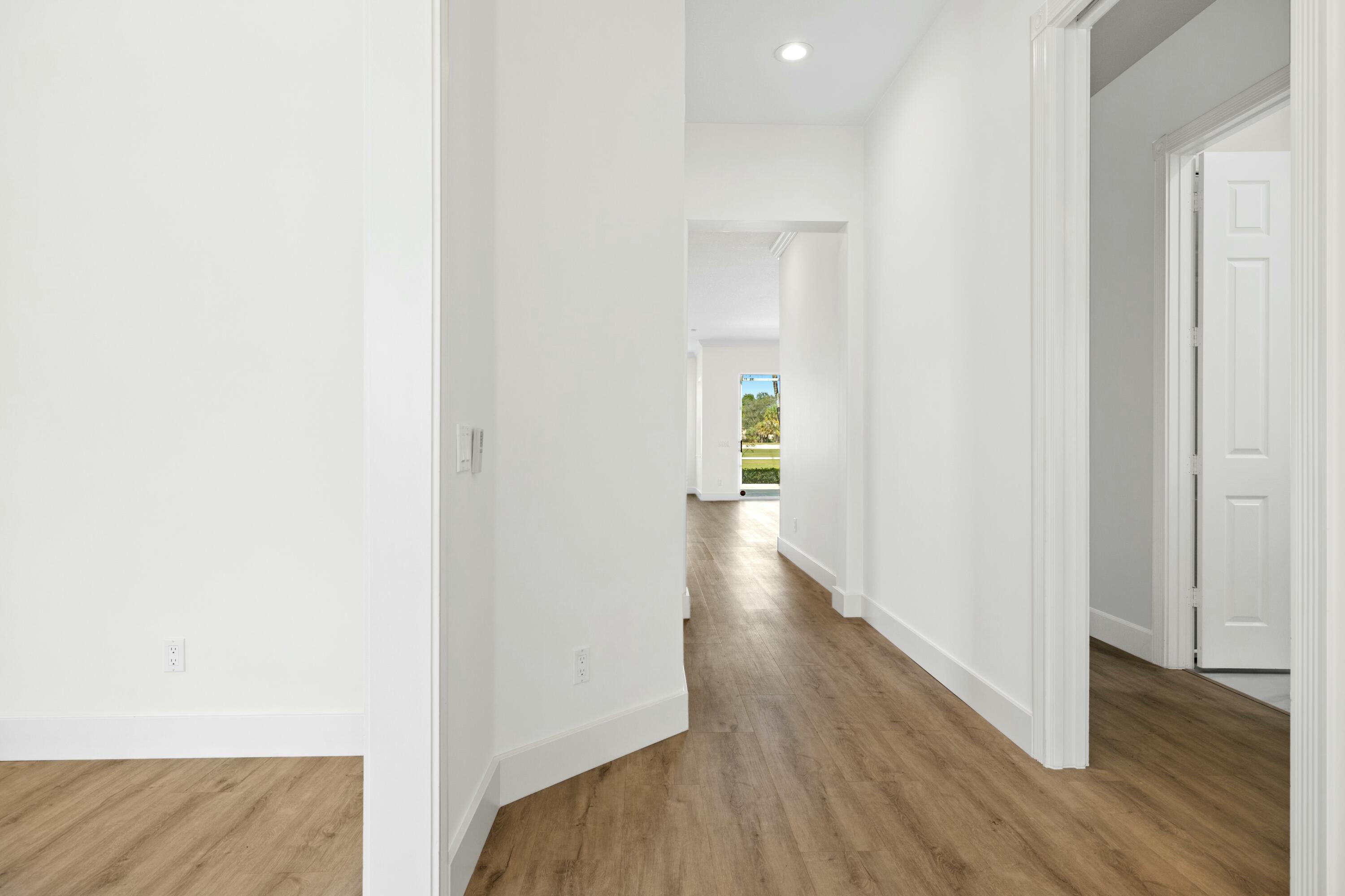 140 Barbados Drive Jupiter, FL 33458 - Photo 27 of 42 a view of a hallway with wooden floor